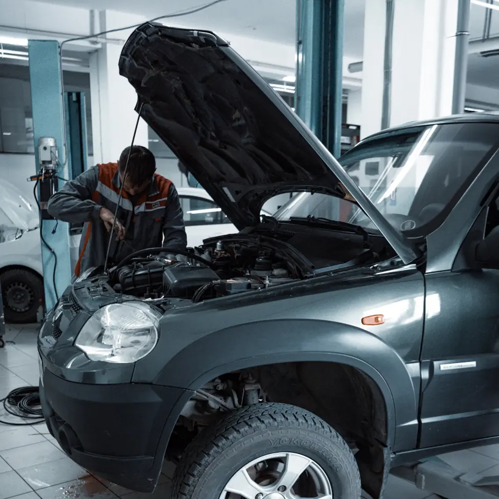 A man working on the components of a car