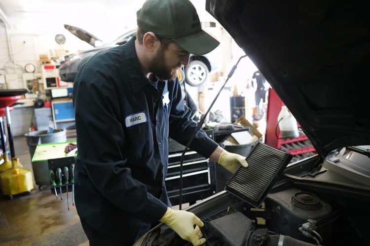 An auto mechanic working on a vehicle
