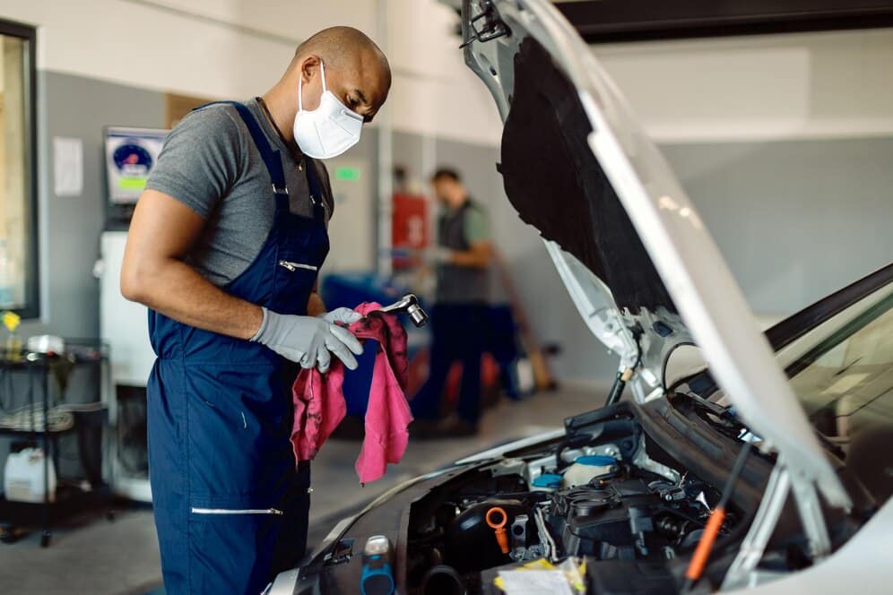 mechanic carrying out routine car maintenance in the workshop