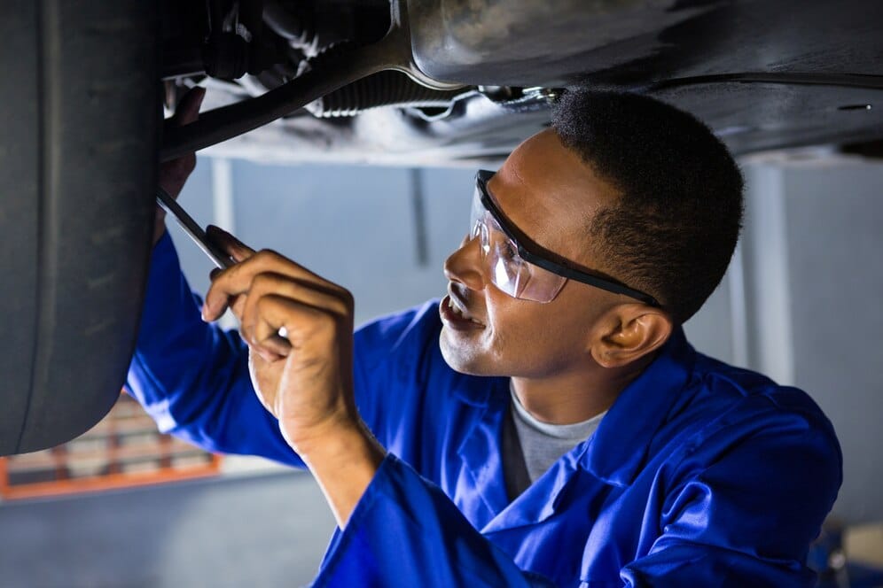 mechanic examining a car tire