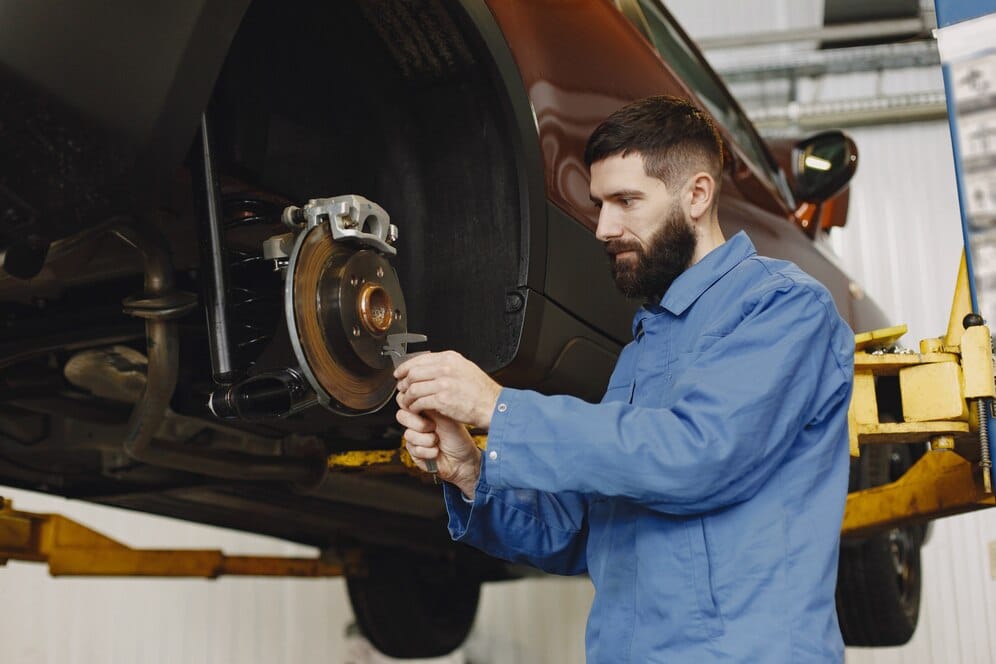 Mechanic working on wheel alignment