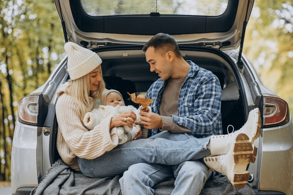 Family sitting at the trunk of the car, safety checks Chadds Ford,
family car safety inspection,
comprehensive vehicle checks