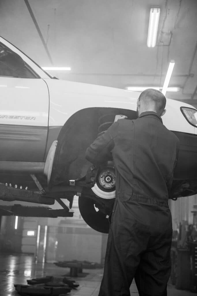 A Welsh Automotive mechanic fixing squeaking brakes