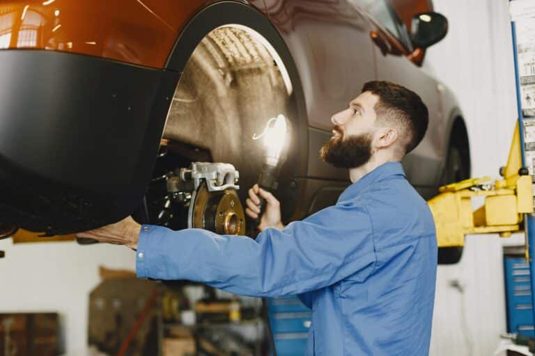 A mechanic replacing bad brakes on a car