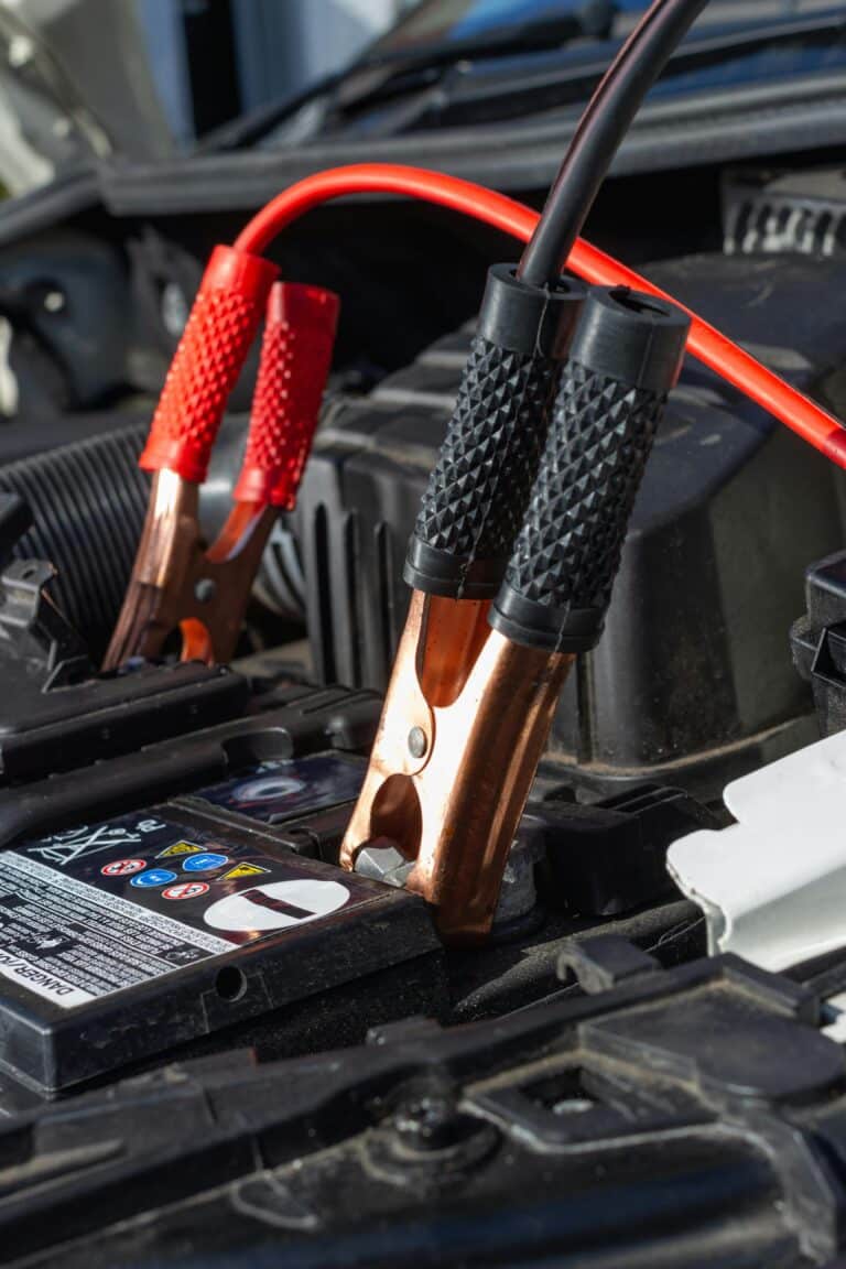 a car battery hooked up to jumper cables