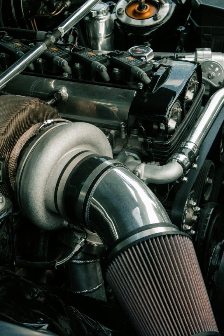 a closeup of an enginer air filter under the hood of a car