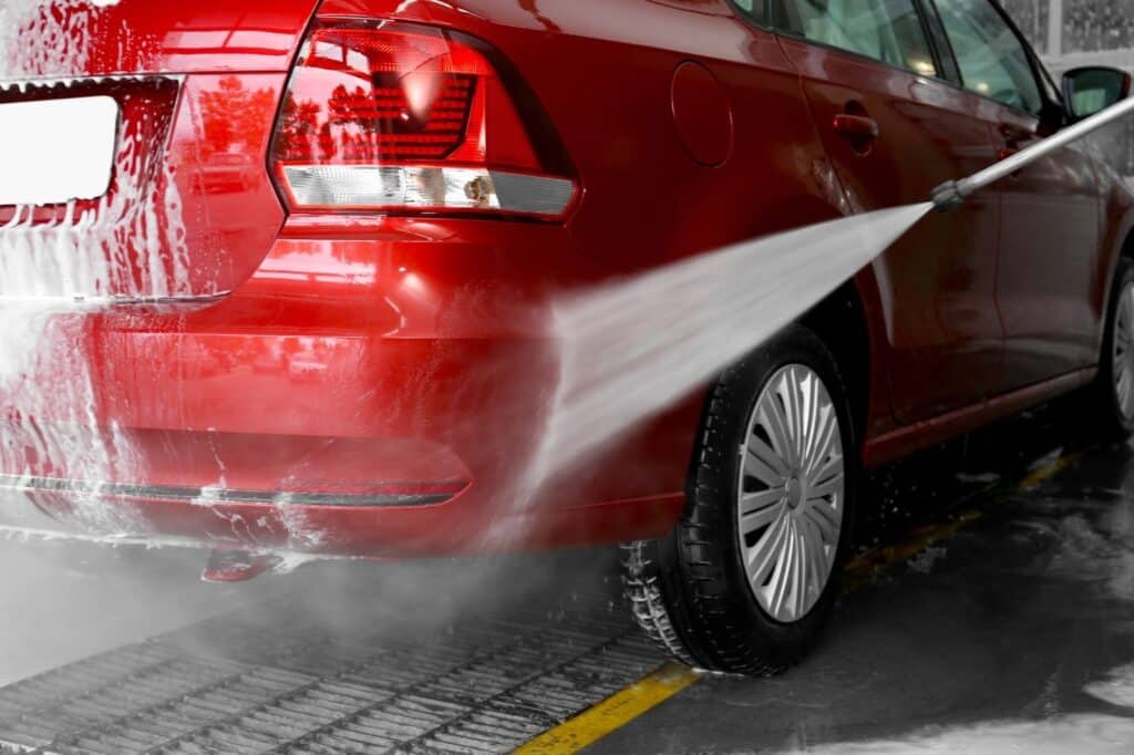 Red car being powerwashed