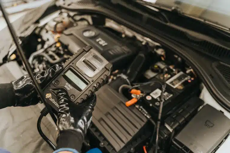 a professional automotive techincian testing a car battery.