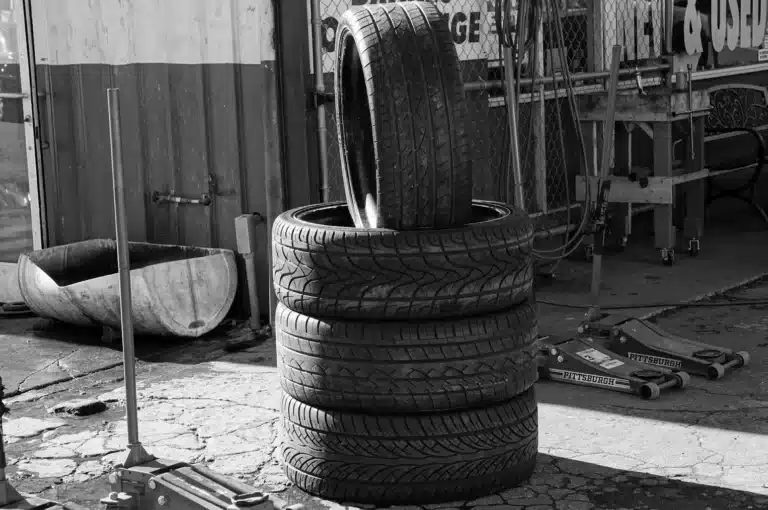 a pile of tires at an auto repair shop.